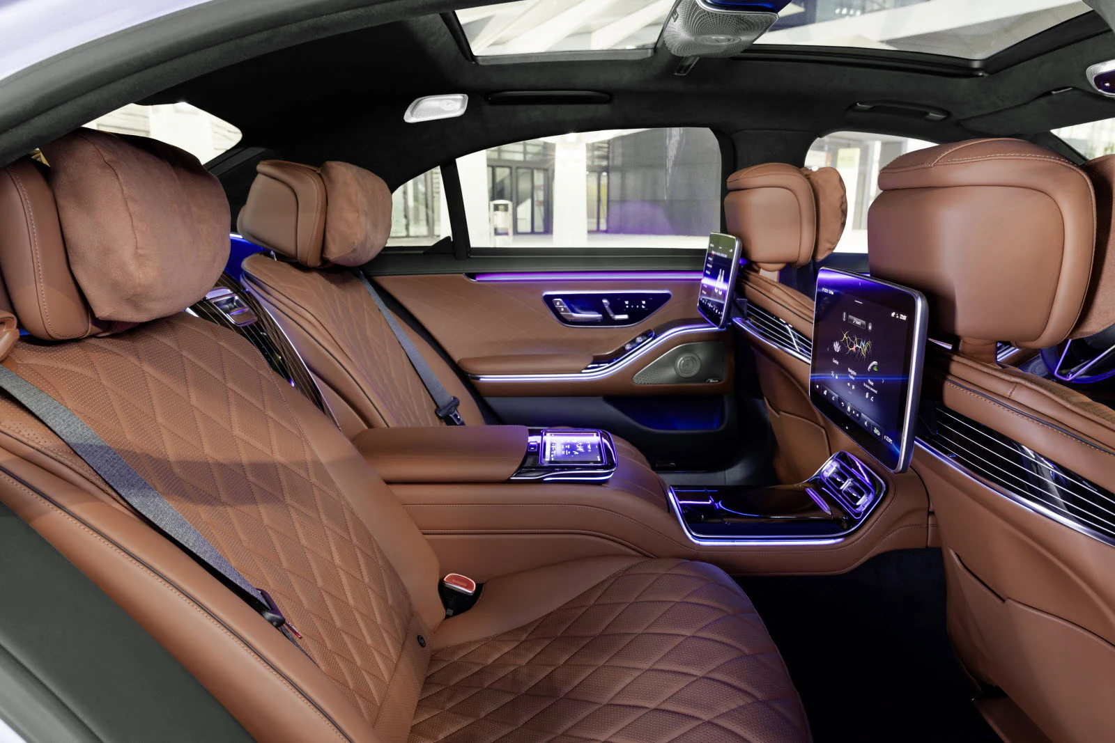 Luxury rear cabin with quilted leather, ambient lighting, and rear-seat entertainment