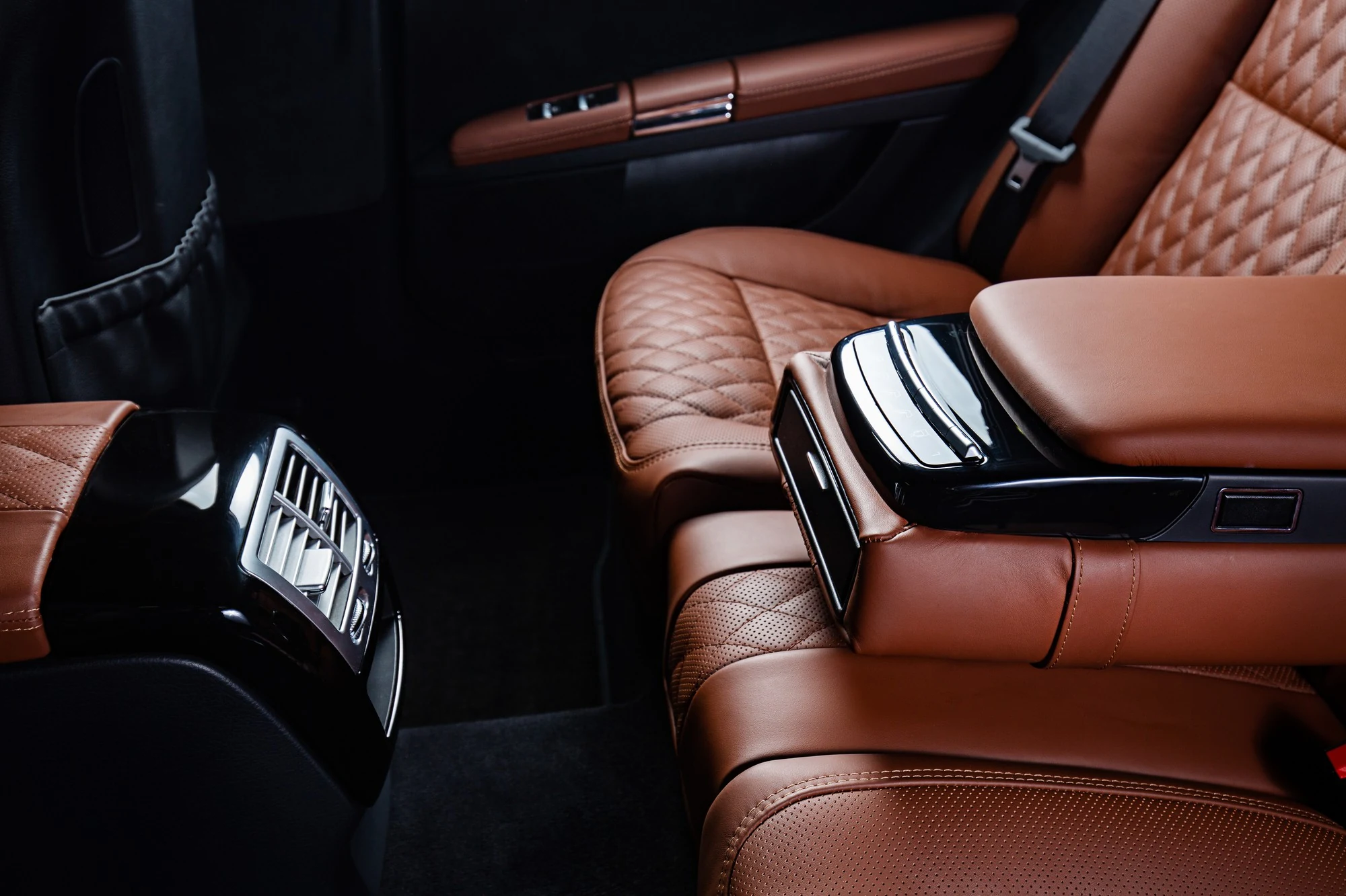 Luxury vehicle rear cabin with quilted leather seating and premium finishes