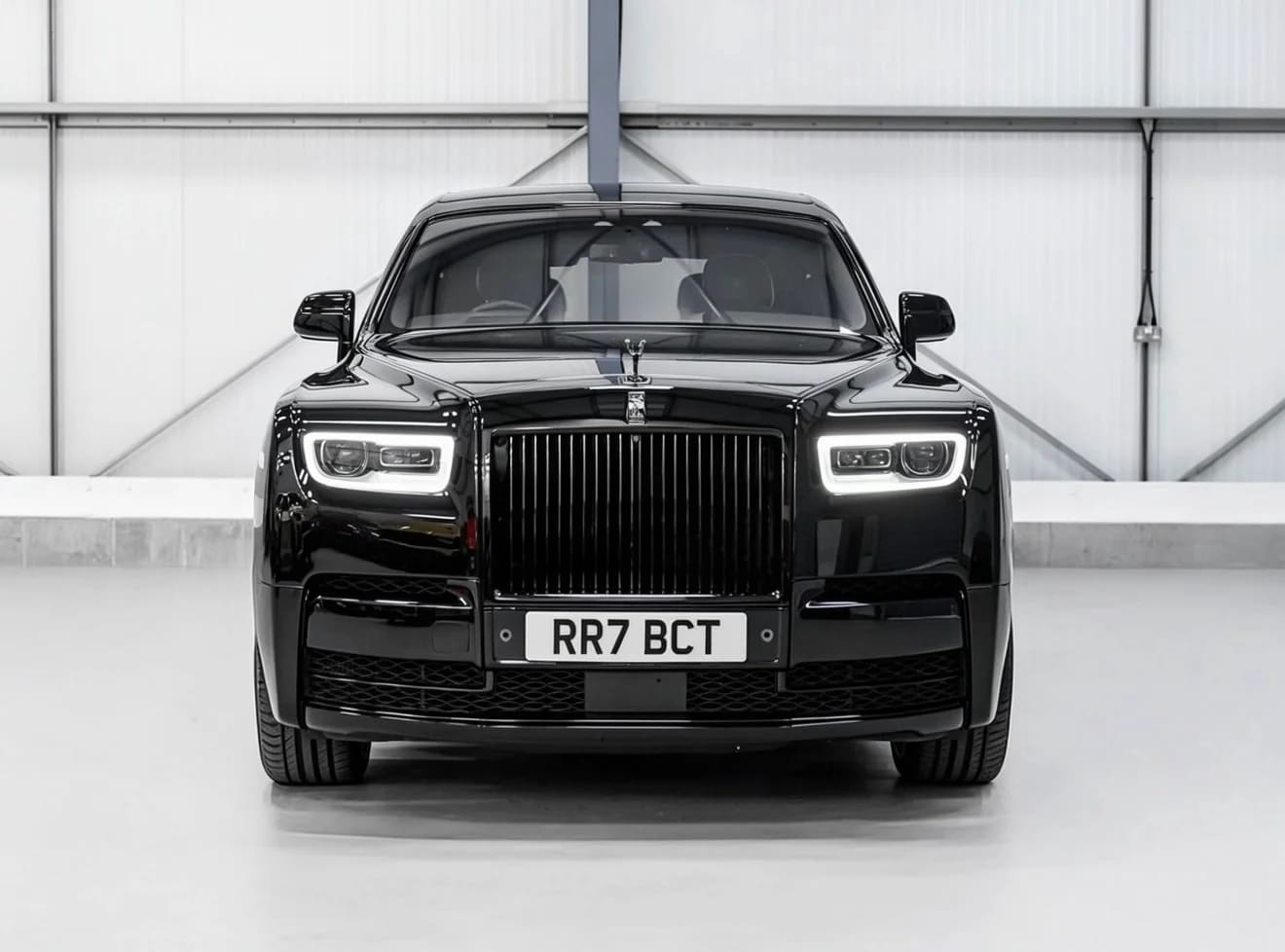 Black Rolls-Royce Cullinan luxury SUV — studio front view