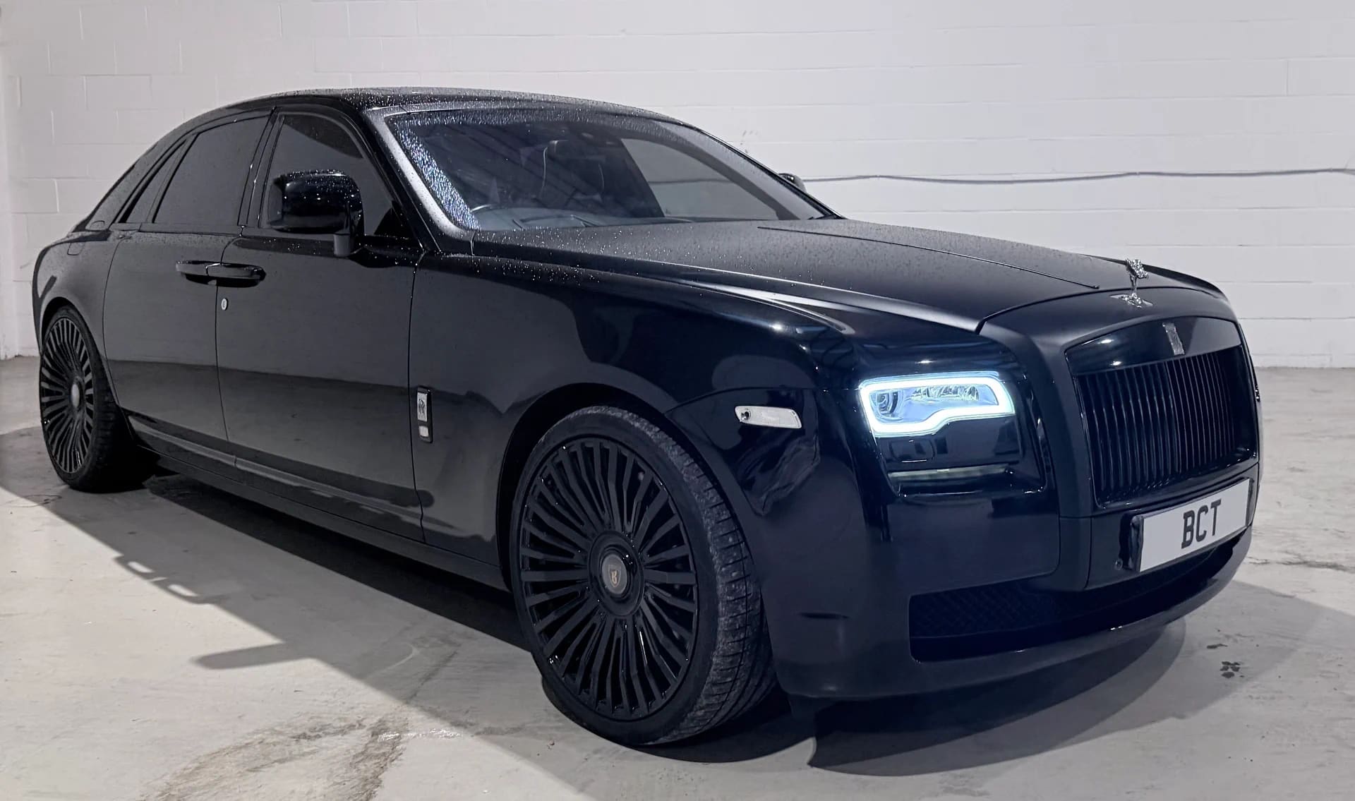 Black Rolls-Royce Ghost luxury saloon — studio three-quarter view