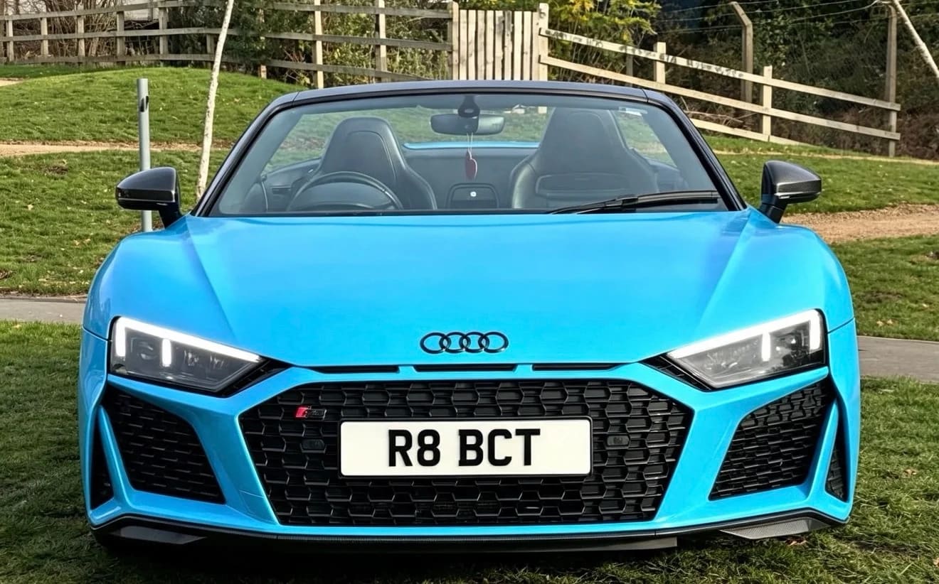 Bright blue Audi R8 Spyder convertible — front view