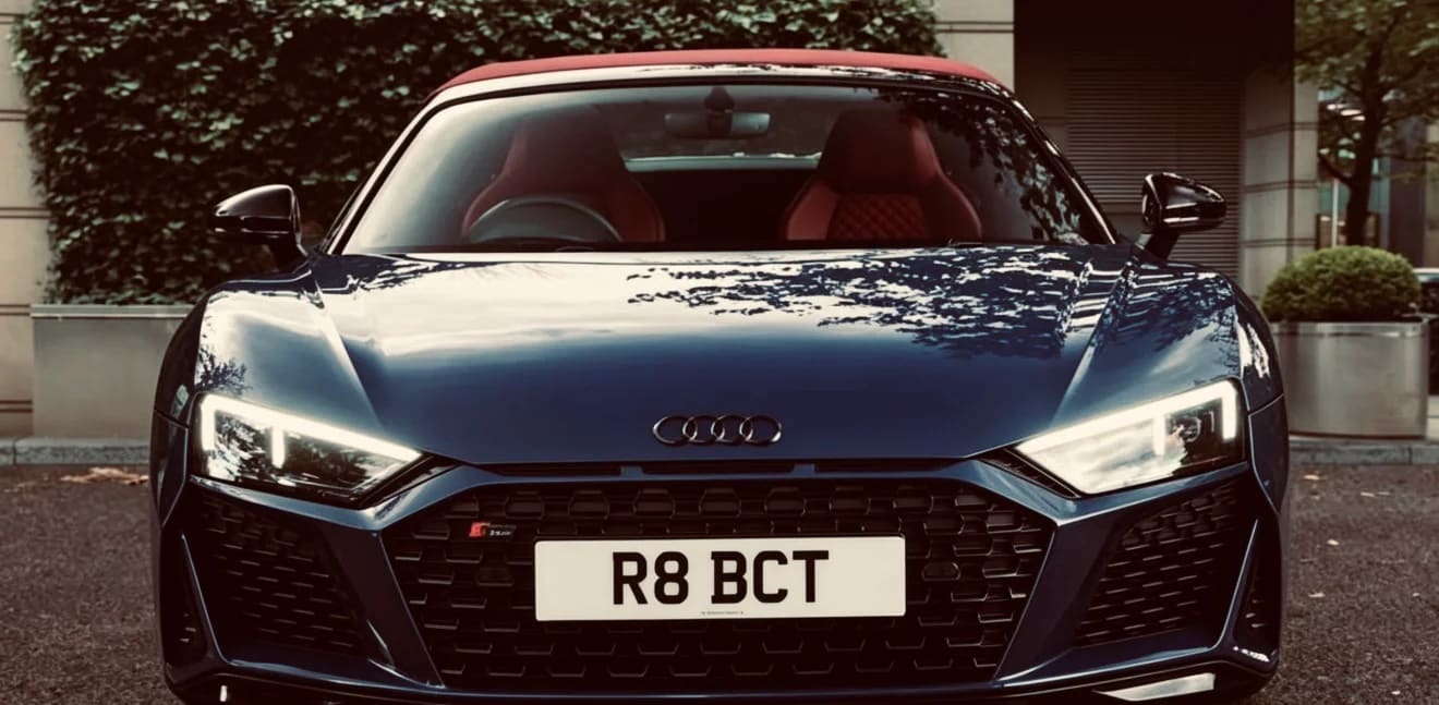 Blue Audi R8 Spyder with red roof and interior — front view