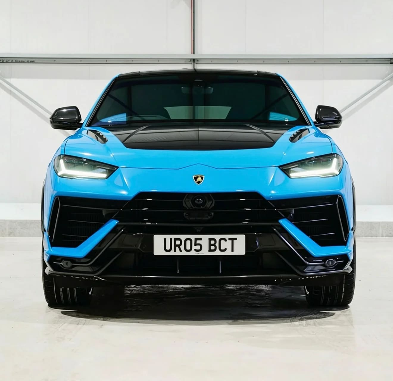 Light blue Lamborghini Urus with black bonnet — front view