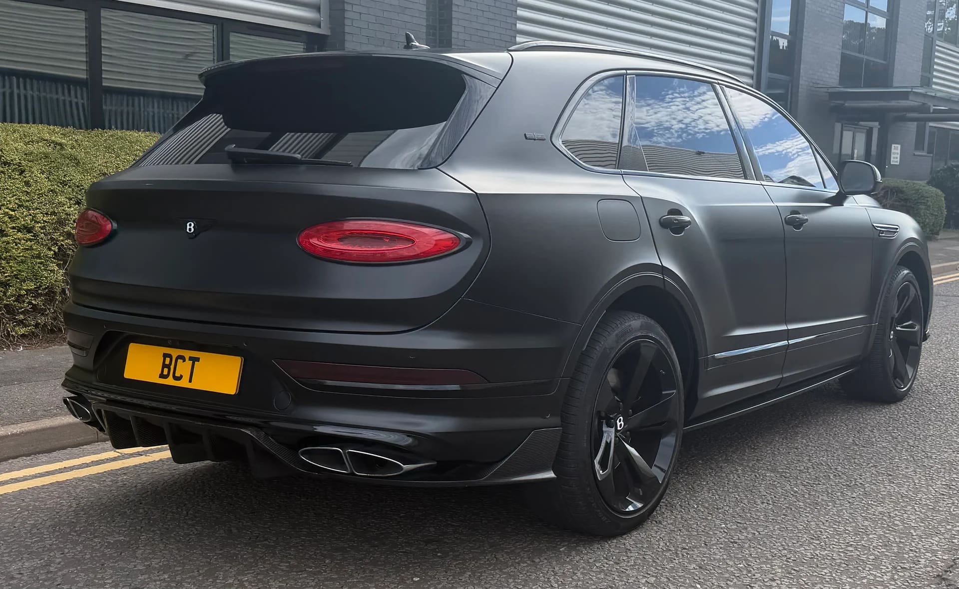 Matte black Bentley Bentayga SUV — rear three-quarter view