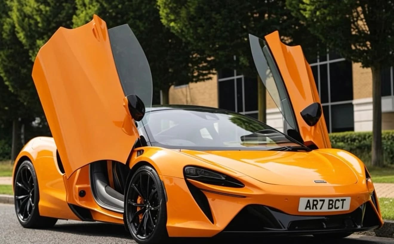Orange McLaren Artura supercar with butterfly doors open — chauffeur-driven hire UK