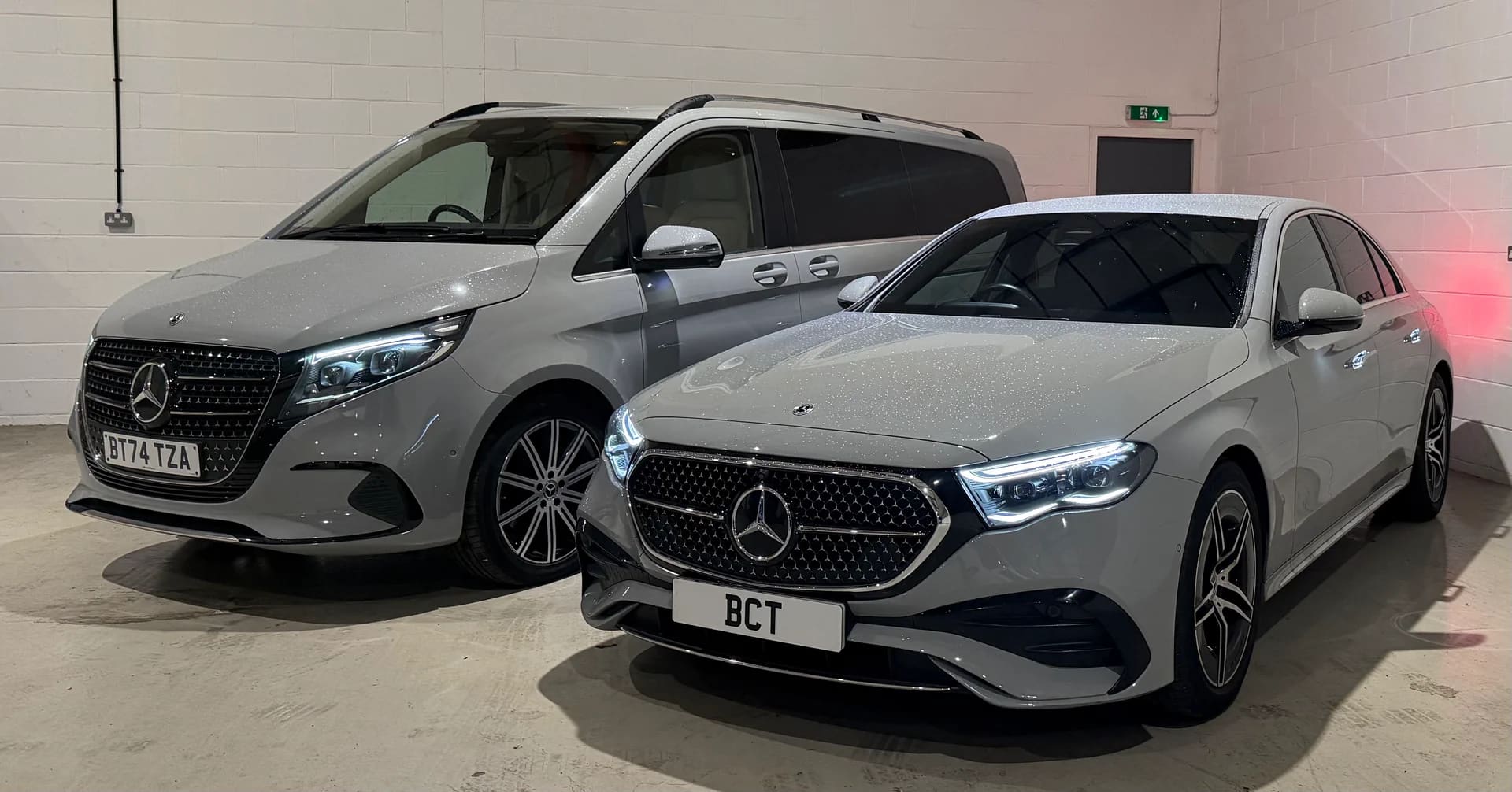 Silver Mercedes-Benz E-Class saloon and V-Class executive MPV in a studio