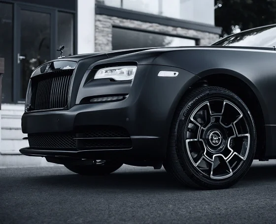 Matte black Rolls-Royce alloy wheel, grille and Spirit of Ecstasy — supercar experience
