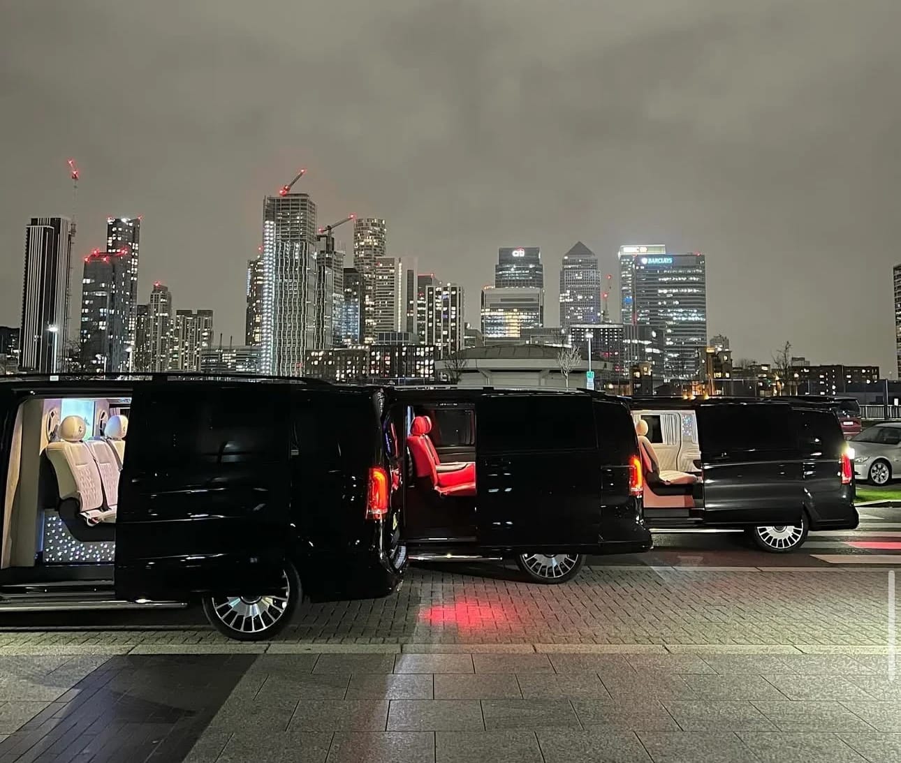 Luxury Mercedes van fleet at Canary Wharf, London, at night