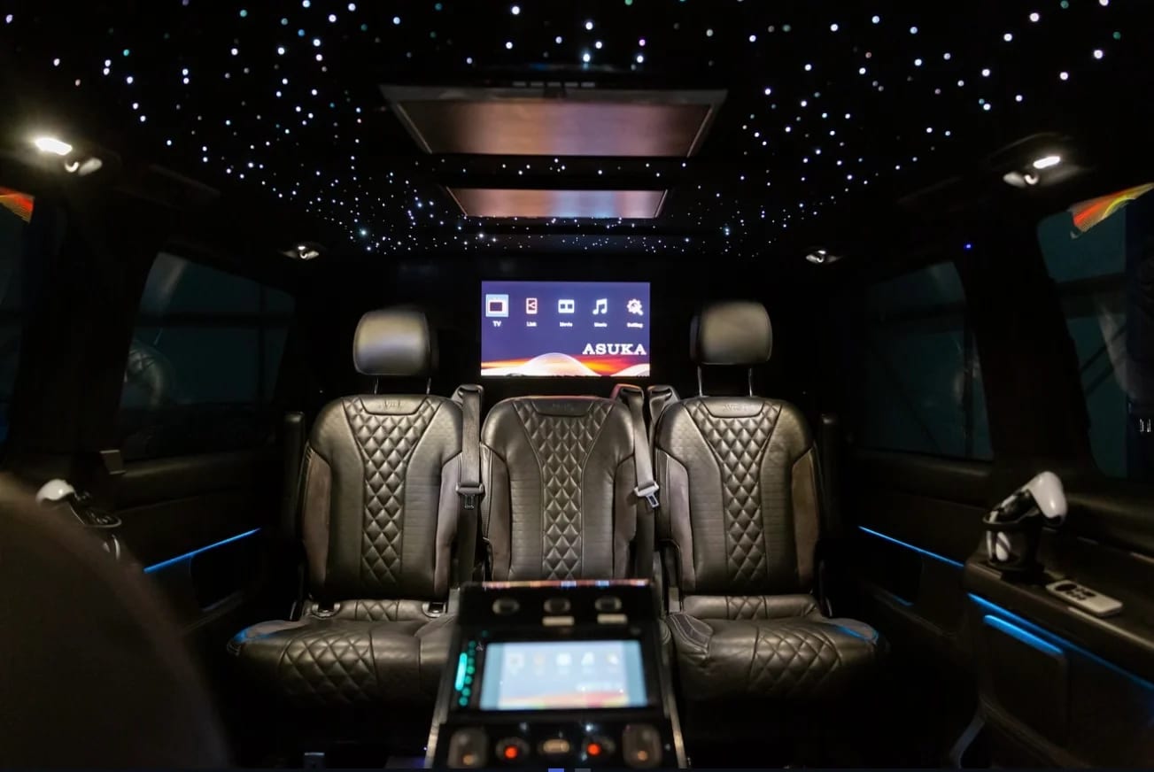 Luxury VIP van interior with starlight ceiling, leather seating and entertainment screens