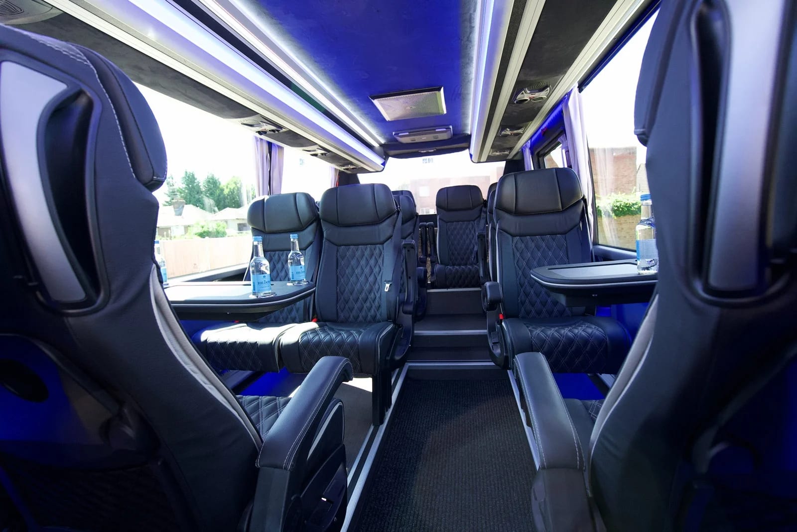 Executive coach VIP interior with leather seating and blue ambient lighting