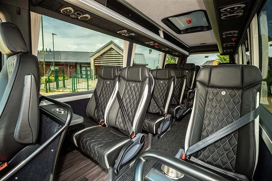 Luxury minibus interior with quilted black leather executive seats