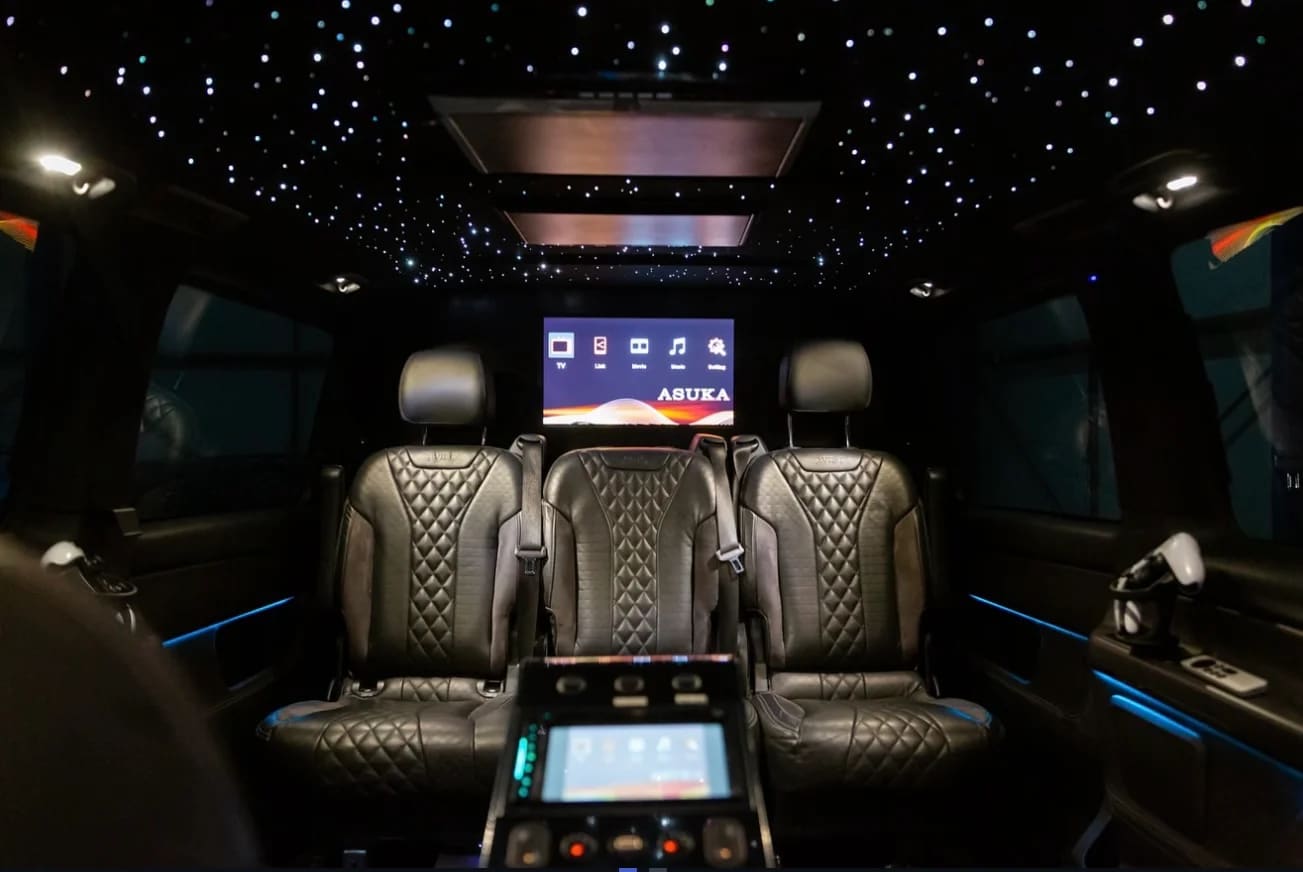 Luxury VIP van interior with starlight ceiling, leather seating and entertainment screens