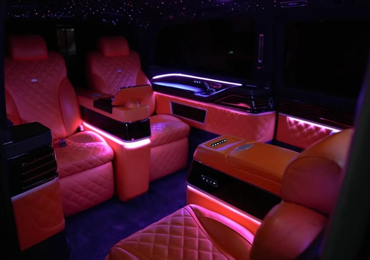 Luxury VIP van interior with orange leather, starlight ceiling and purple ambient lighting
